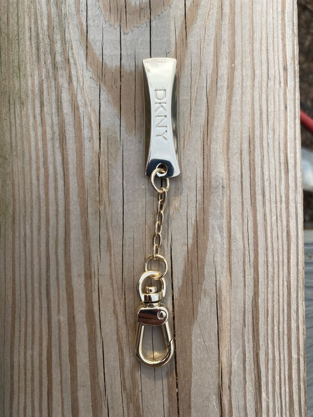 DKNY Gold Tone Key Chain with Branded Bar Bag Charm